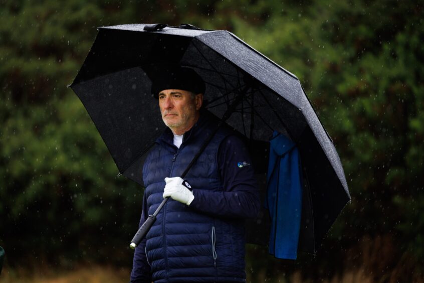 Dunhill Cup Celebrities - The Untouchables and Oceans 12 star Andy Garcia braves the rain on his way to the ninth tee at Carnoustie.