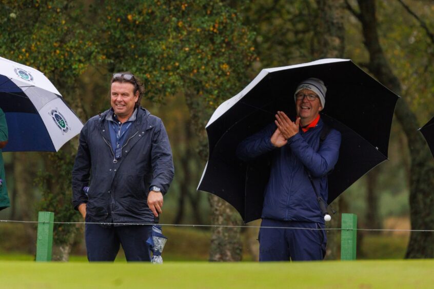 Dunhill Cup celebrities - Catherine Zeta Jones' brothers watch as she celebrates holing her putt.