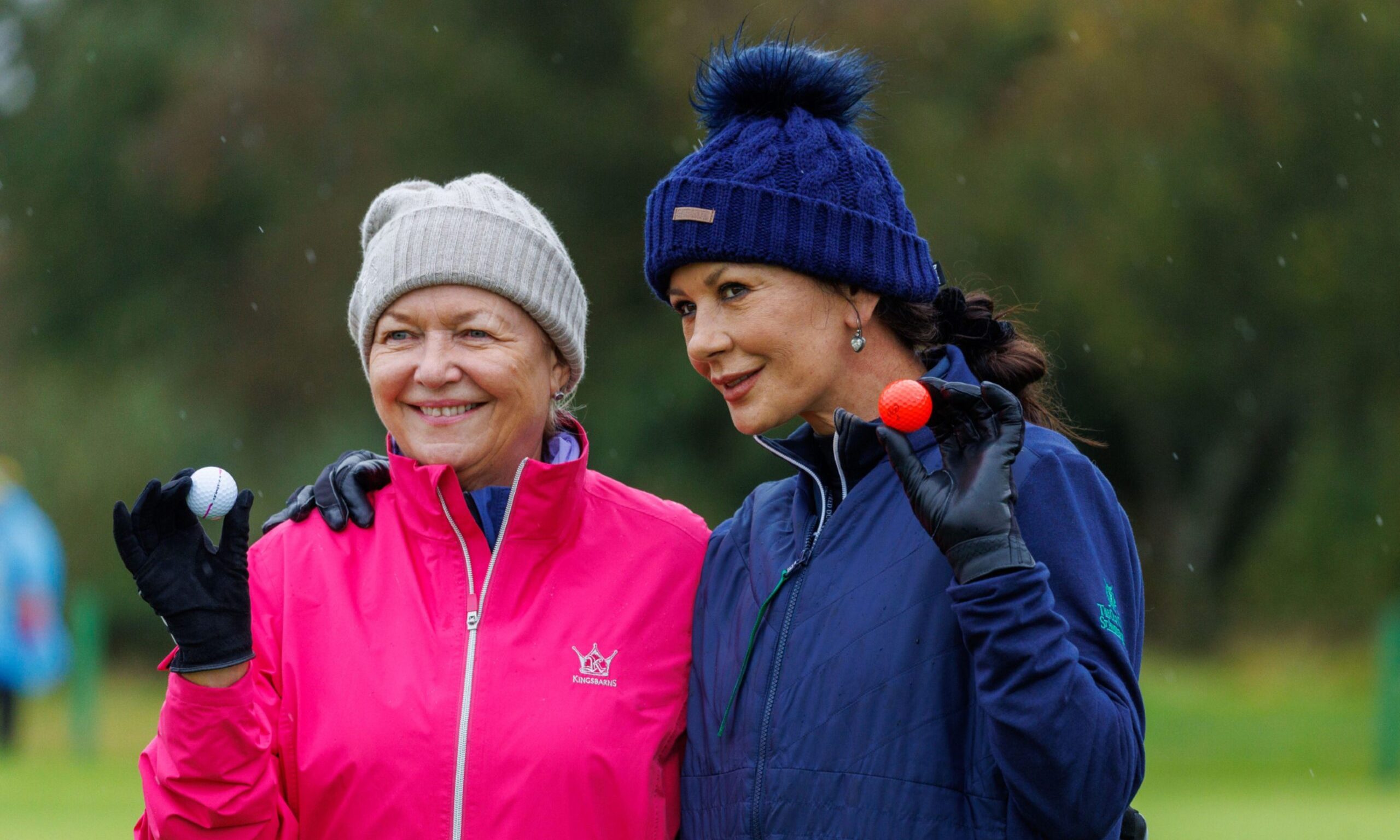 Catherine Zeta Jones celebrates holing her putt on the 8th green with playing partner Gaynor Rupert. Image: Kenny Smith/DC Thomson