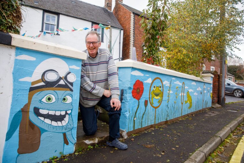 John Mackay with the mural he painted at his home In Errol. 