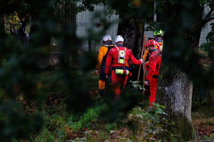 River Tay search teams seen through trees at Strathtay.