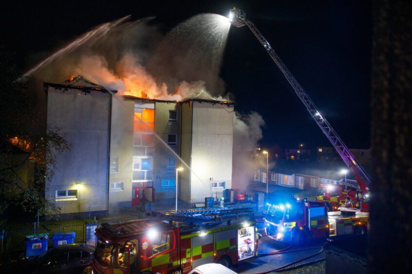 Fire crews fight the blaze which engulfed the flats in Lochgelly.