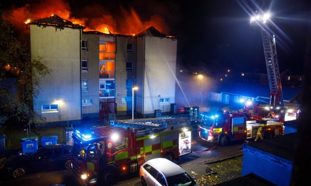 Multiple fire crews tackle fire which has engulfed a block of flats in Lochgelly.