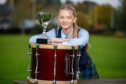 Flora McNab, with tenor drum and world championship trophy.