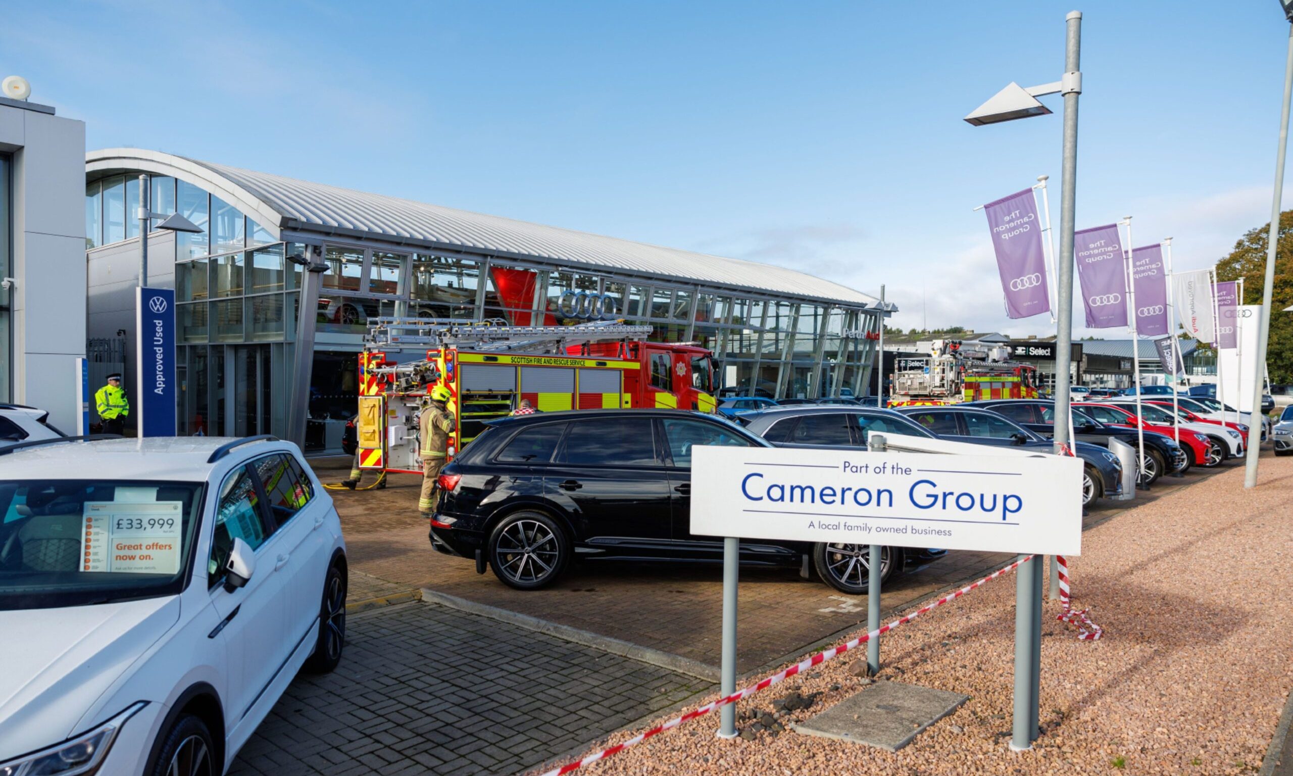 Fire crews tackle fire at Cameron Motors in Perth on Thursday.