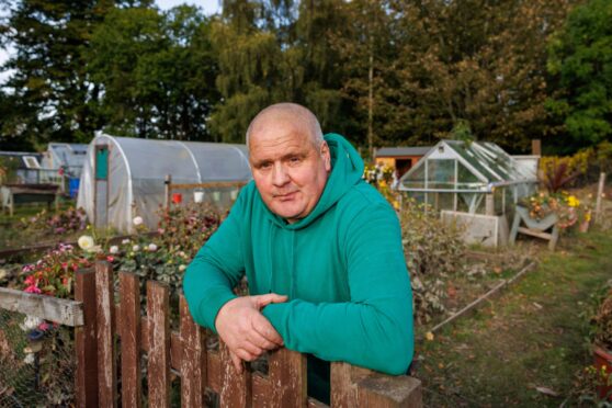 Kenny Orrock lening on his fence at the Moncreiffe Island allotments.