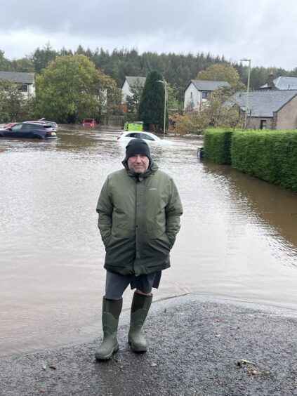 Resident Simon Goulding in flooded Heron Rise, Dundee.