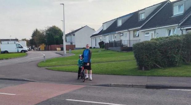 Christopher Black and son James wait to cross Bute Drive, North Muirton.