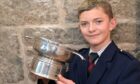 Callan Erskine with the DR DS MacLaggan Memorial Trophy for Piobaireachd under 16.