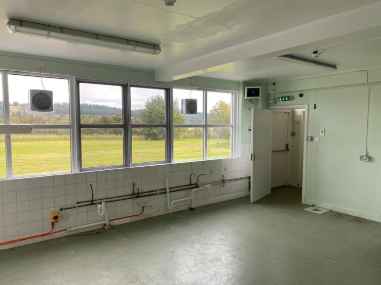 Forteviot School toilets with tiled walls and pipes 