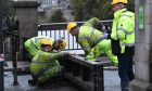 Workers installing floodgates on the Queens Bridge in Perth.