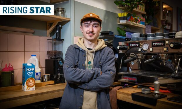 Lewis standing in front of the espresso machine inside EH9 Espresso.