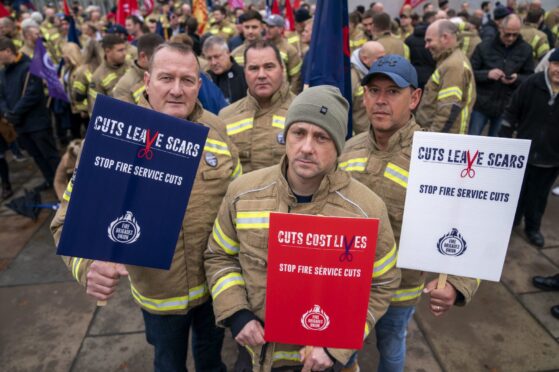 A recent rally against fire service cuts at the Scottish Parliament. Image: Jane Barlow/PA