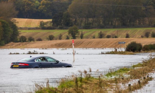 A stranded car on the flooded B954 between Meigle and Alyth. Image: Steve MacDougall/DC Thomson