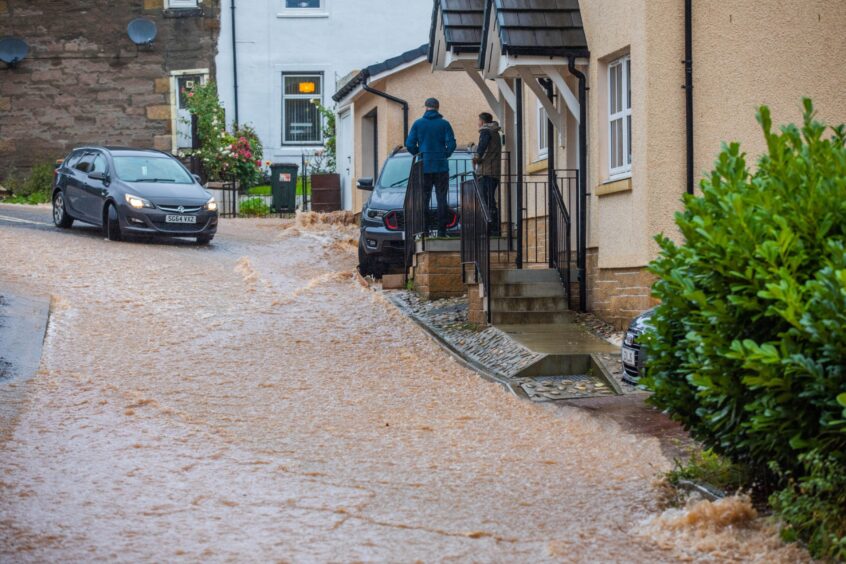 Flood water pouring down street close to homes in Windsor Terrace, Perth