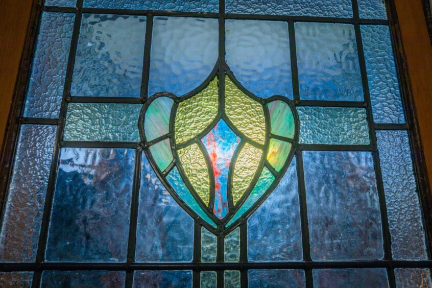 The Dundee house retains its original stained glass window.