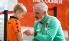 Dundee United boss Jim Goodwin signs a young fan's shirt. Image: Steve Brown/DC Thomson.