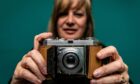 Image shows Lesley Brown holding her Everyday Heirloom the camera that belonged to her late father. The camera, a Kodak Retina 1a is in the foreground with Lesley slightly blurred in the background.