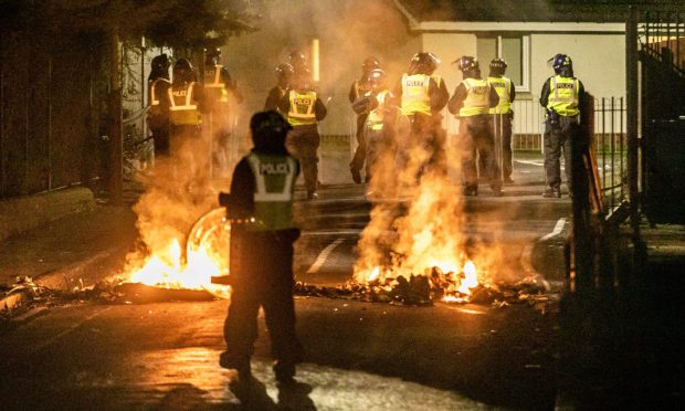 Riot police in Kirkton after fires were started. Image: Steve Brown/DC Thomson
