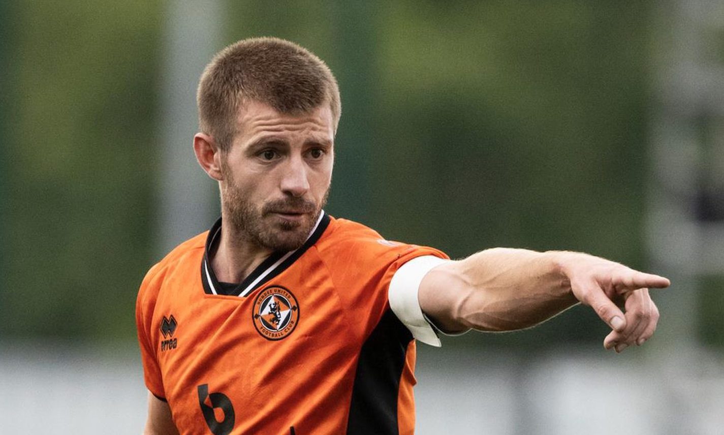 Dundee United captain Ross Docherty points the way