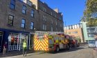 Emergency services have closed the road where South Tay Street meets Westport, Dundee.