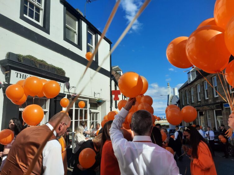 Orange balloons were released outside the bar Aidan Reid worked in.