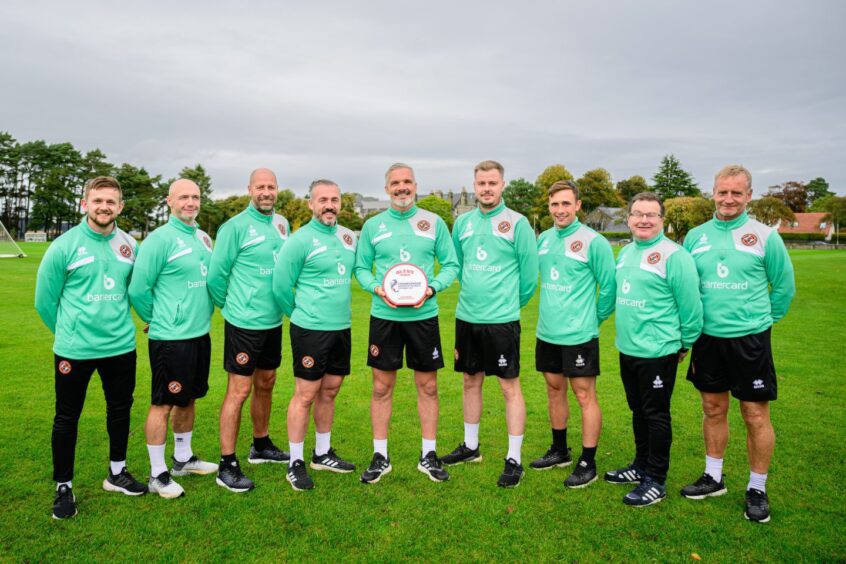 Jim Goodwin is pictured with the entire Dundee United backroom staff
