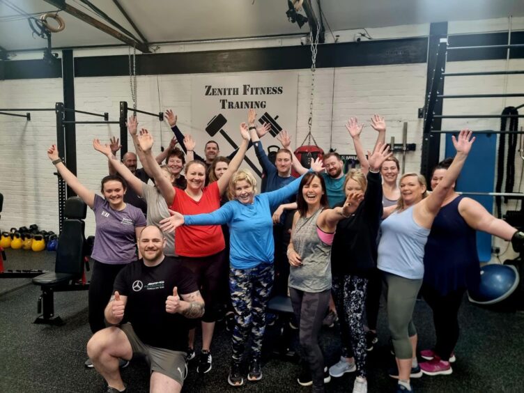 Zenith fitness training regulars in gym gear