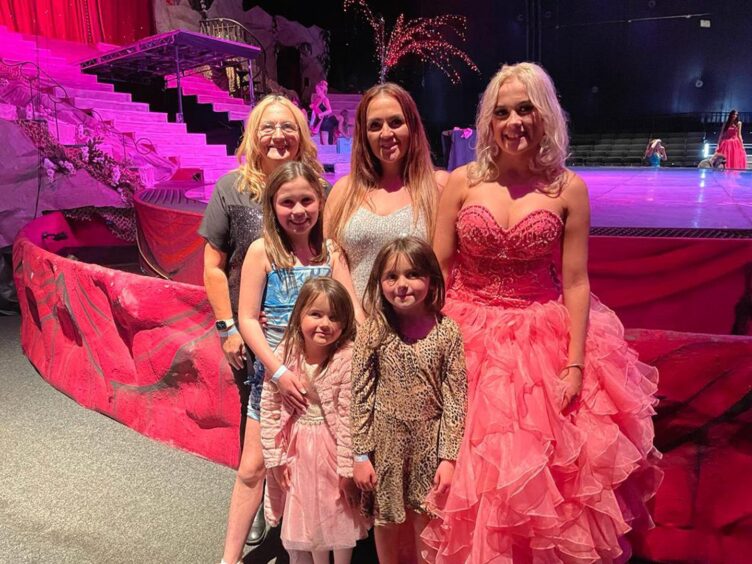 Mackenzie Connor in ballgown, with family next to the stage at the beauty pageant in Blackpool