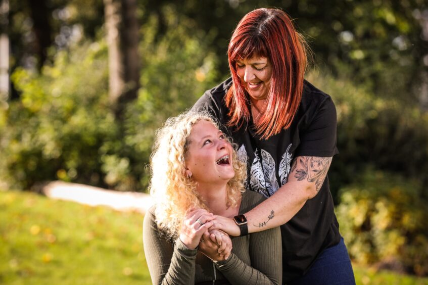 Ruby McDonald smiling and hugging her foster mum Fiona McDonald.