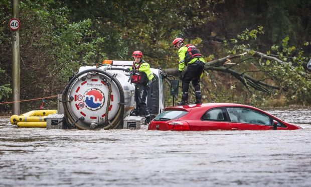 A car stuck in floodwater on Claverhouse Road, Dundee. Image: Mhairi Edwards/DC Thomson