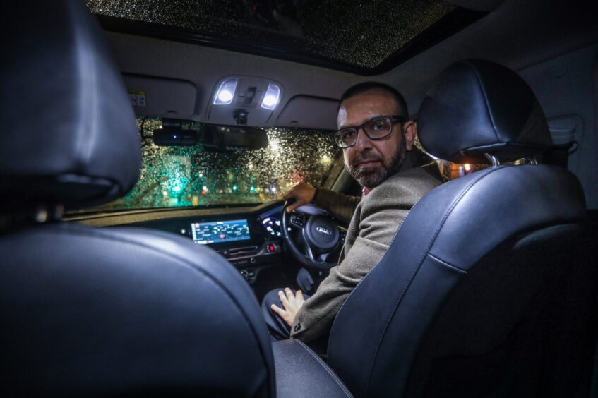 Qaiser Habib in his taxi.