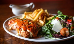 A plate of chicken parmesan, chips and salad at The Stag in Forfar.