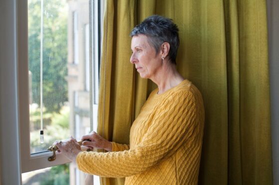 woman looking out window