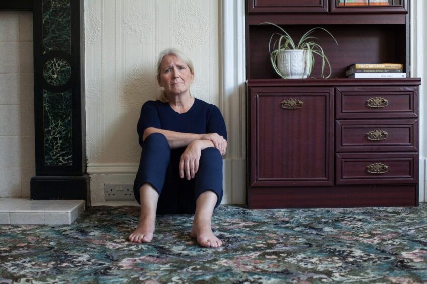 concerned woman sitting on floor