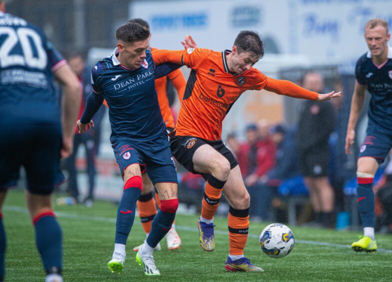 Dundee United's Declan Glass battles Josh Mullin