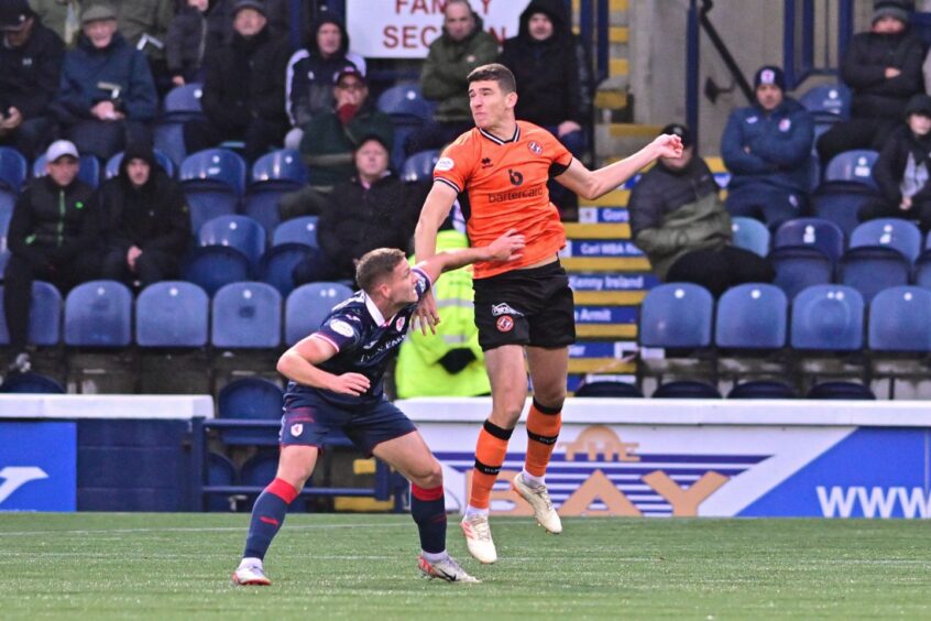 Ross Graham win an aerial challenge for Dundee United