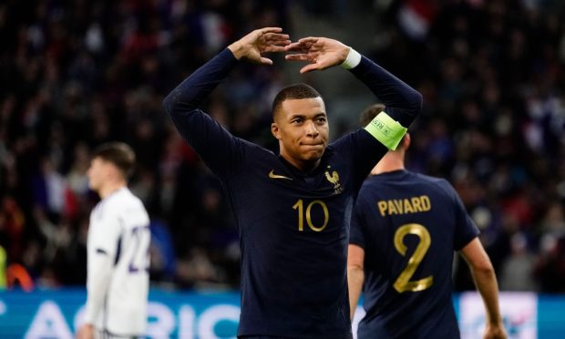 Elite France striker Kylian Mbappe celebrates scoring from the spot against Scotland.