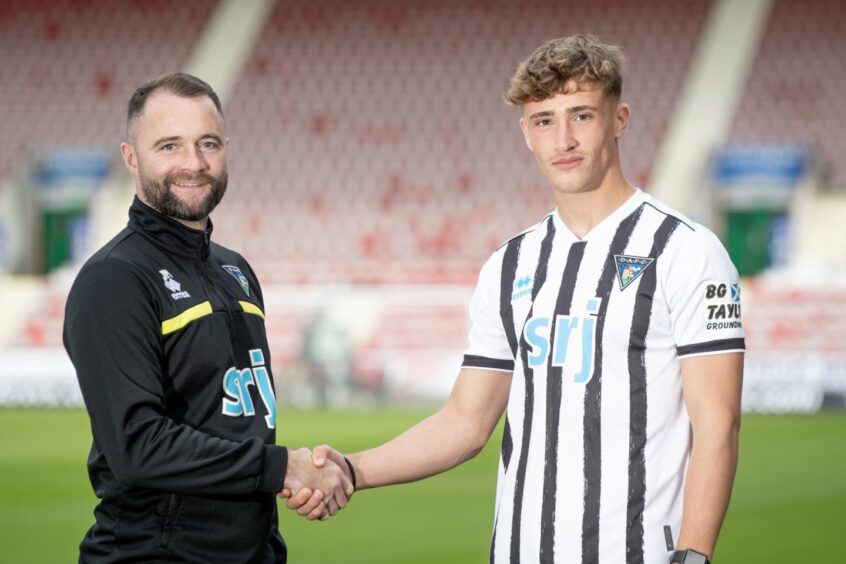 Dunfermline Athletic FC manager James McPake and striker Lewis McCann shake hands.