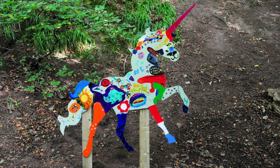 This unicorn from the Letham Glen Unicorn Trail says be happy. 