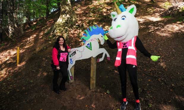 Jade Burnett, left, from Fife College Students Association, shows off one of the unicorns from the Leven Unicorn Trail.