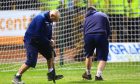Groundsmen Brian and Brian Robertson work on the Dundee pitch. Image: Shutterstock