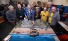 Members of Gothenburg Gamers from East Lothian
and Kirrie Wargames Club officials with the Neverland game. Image: Paul Reid