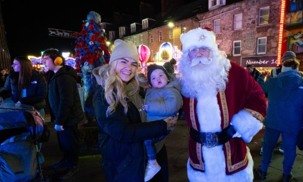 Santa meets Emma Smith and one-year-old Blake Findlater in Montrose. Image: Paul Reid