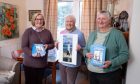 Carolyn Siddalls, Helen McDiarmid and Jill Kerr with copies of the The Lighthouse Boy. Image: Paul Reid