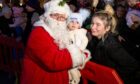 Santa with Mason Gibson who is 8 months old and mum Steph. Image: Paul Reid