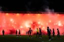 Rangers fans set off flares as the match eventually kicked off, delaying things once more. Image: SNS