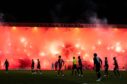 Rangers fans lit up Dens Park's Bob Shankly Stand with pyro. Image: SNS
