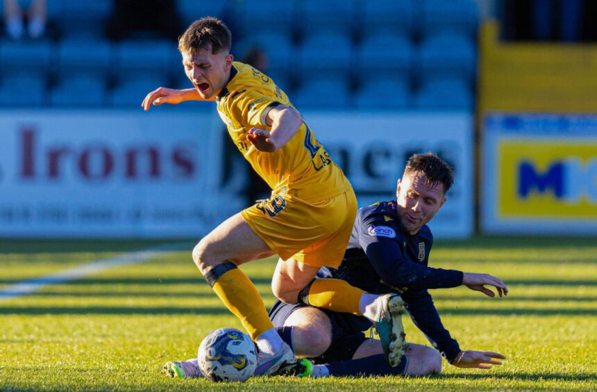 Jordan McGhee tackles James Penrice as Dundee edged out Livingston. Image: SNS