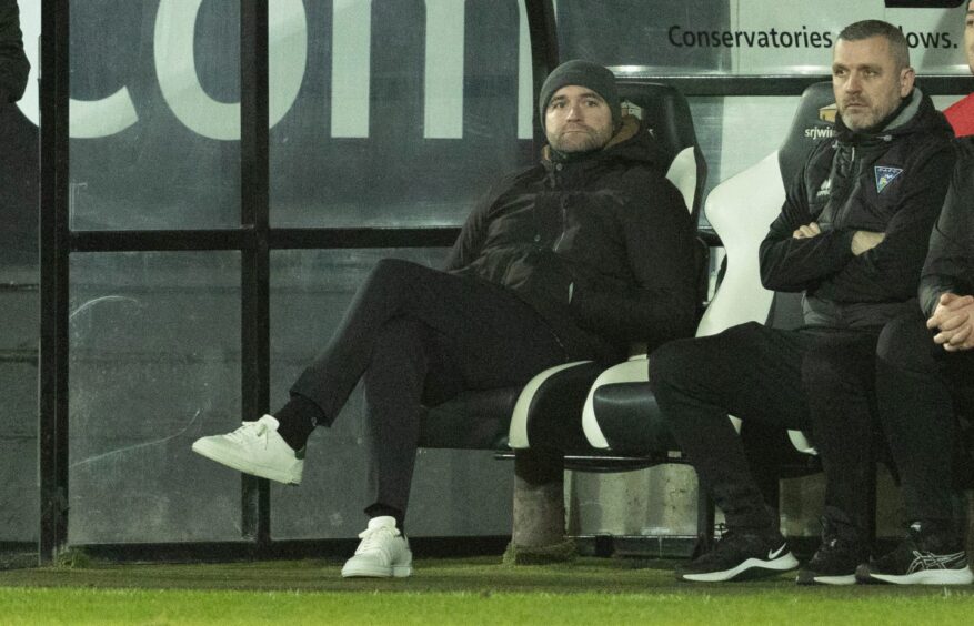 Dunfermline Athletic manager James McPake sits in the East End Park dugout. Image: SNS.